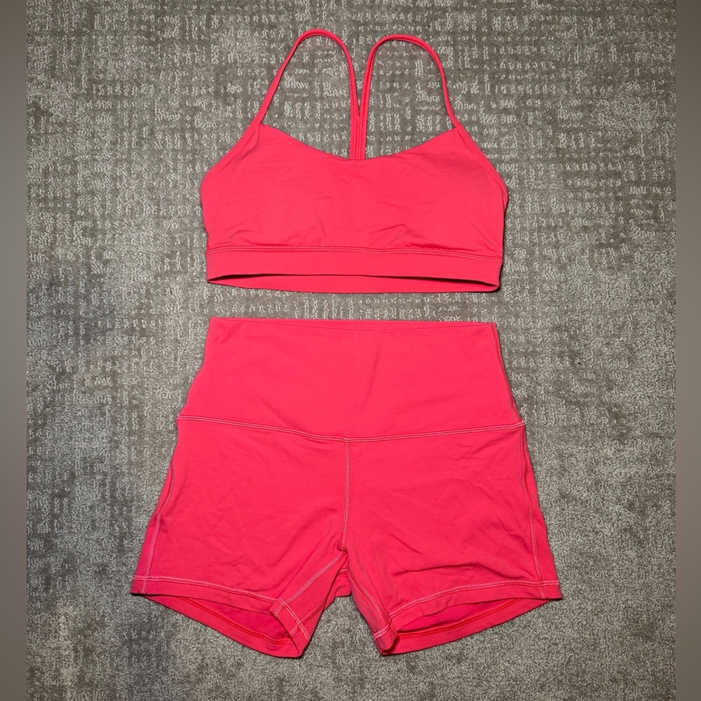 Pink two piece Lululemon shorts and sports bra set
